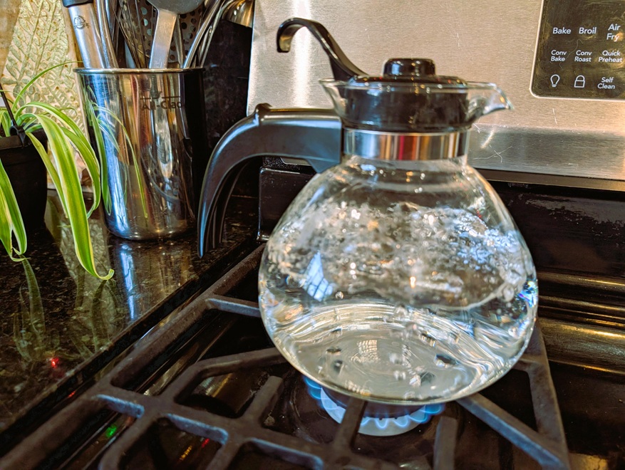 Glass tea pot boiling water.